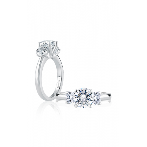 Two white gold three stone diamond engagement rings.