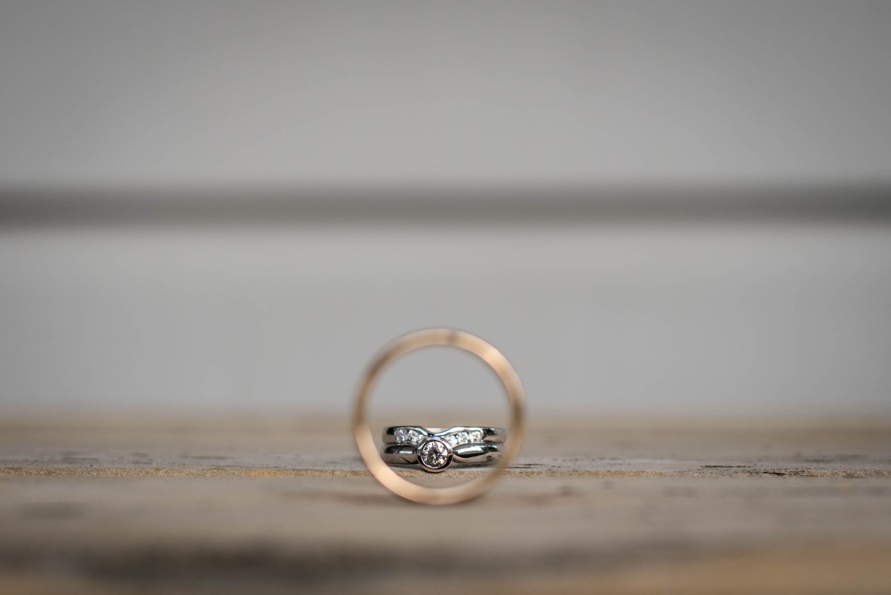 A complex diamond ring inside a classic unadorned wedding band.