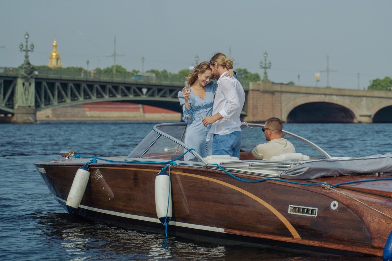 A couple embraces on a luxurious private boat on a river