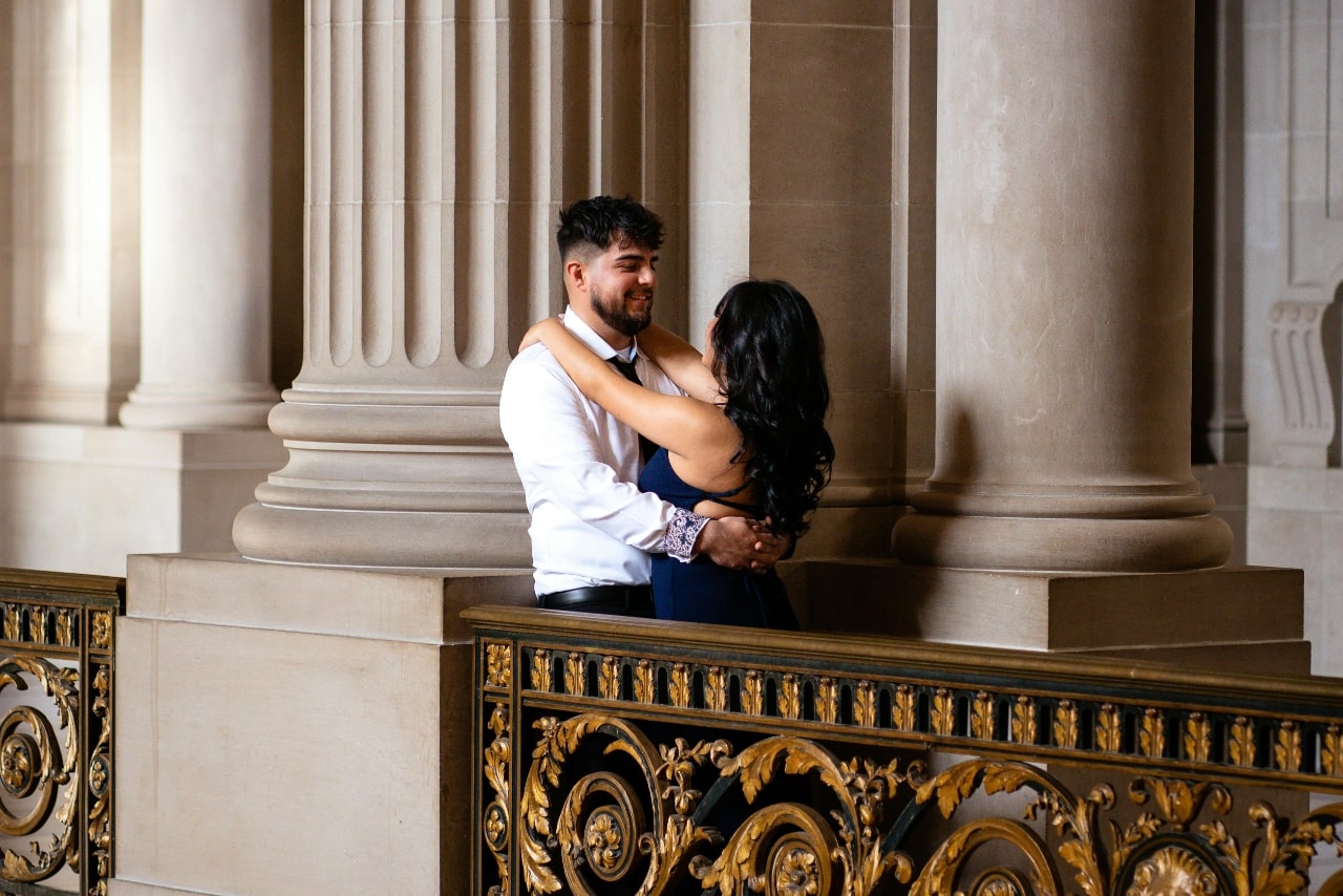 A couple on a balcony after the guy proposed to the woman