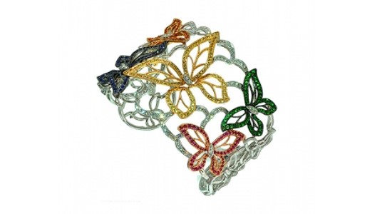 a large silver cuff bracelet with colorful butterfly motifs
