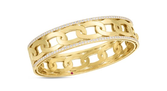 a yellow gold bangle bracelet featuring diamond details