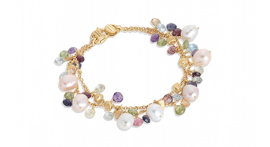a yellow gold chain bracelet featuring a myriad of colorful gems