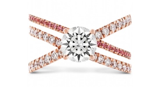 A rose gold, multi band ring with pink sapphire side stones