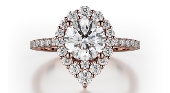 a rose gold engagement ring with a round cut center stone and a unique silhouette
