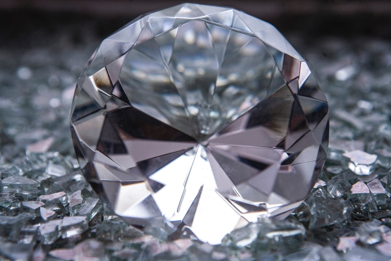 close up image of a round cut diamond sitting among shards of stone