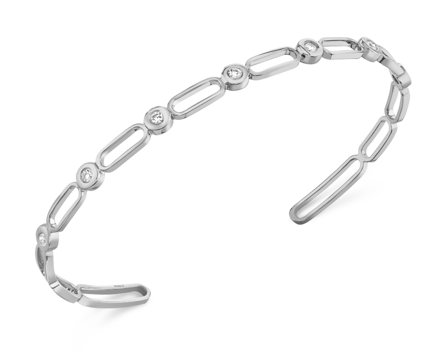 A white gold open link bangle with bezel set diamonds