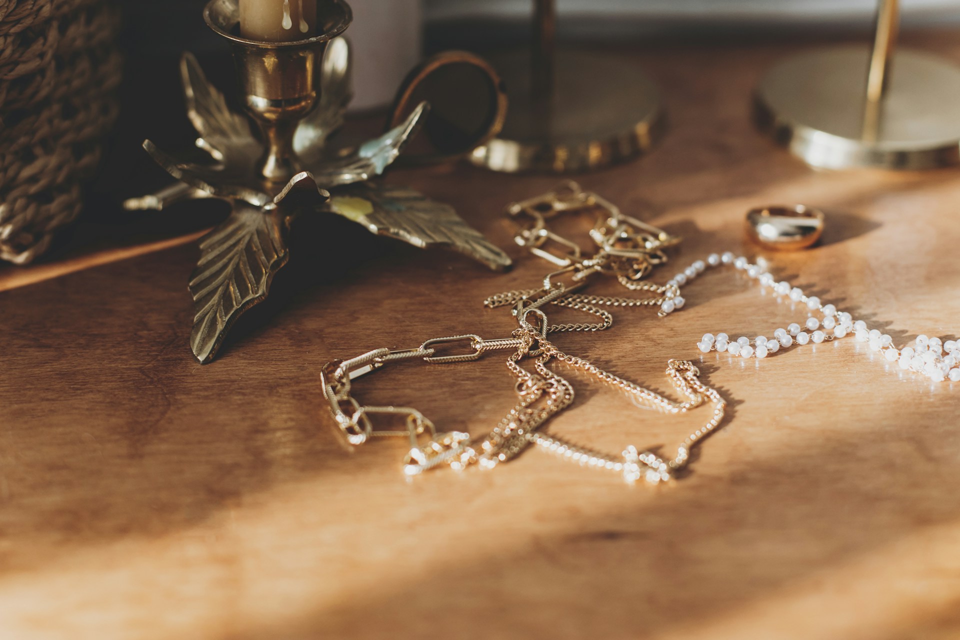 necklaces and a ring lying on a wooden table