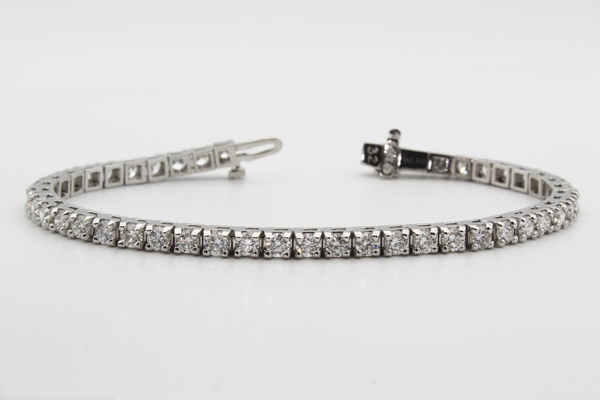 a tennis bracelet on a light gray background