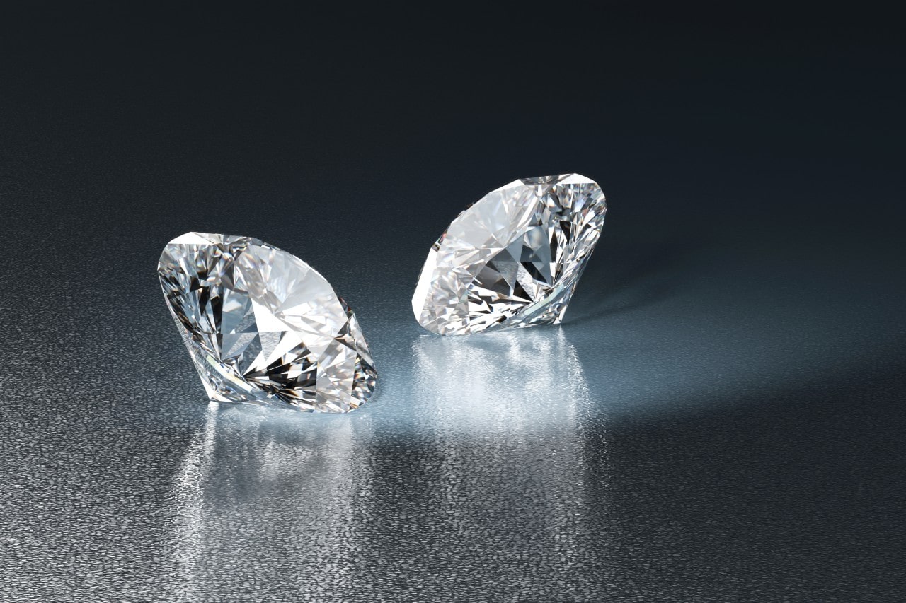 two loose diamonds on table