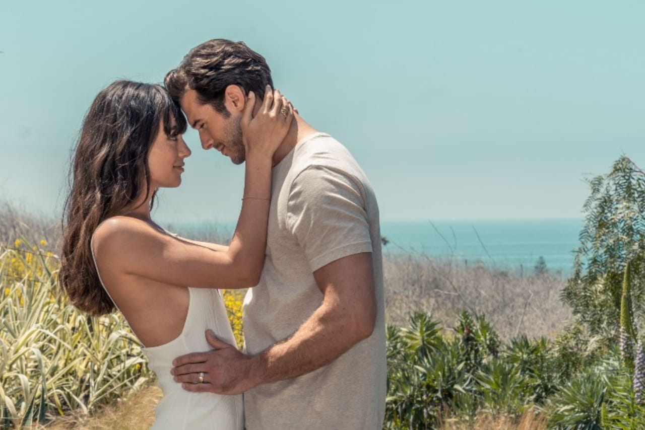 Couple celebrating their honeymoon beachside while wearing their TACORI wedding bands