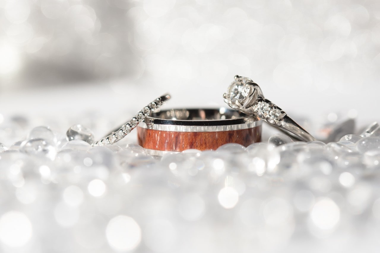 A man and woman’s wedding band, plus an engagement ring A man and woman’s wedding band, plus an engagement ring