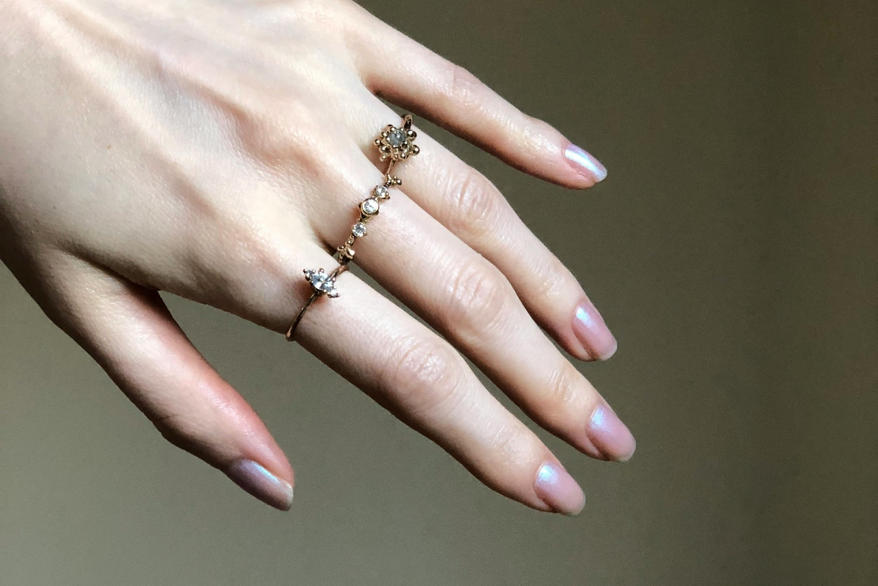 woman hand wearing three fashion rings