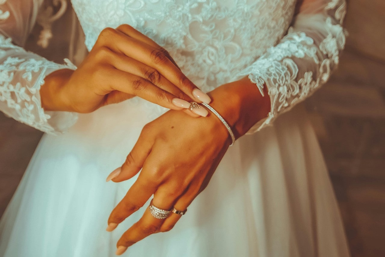 bride putting on a diamond bracelet bride putting on a diamond bracelet