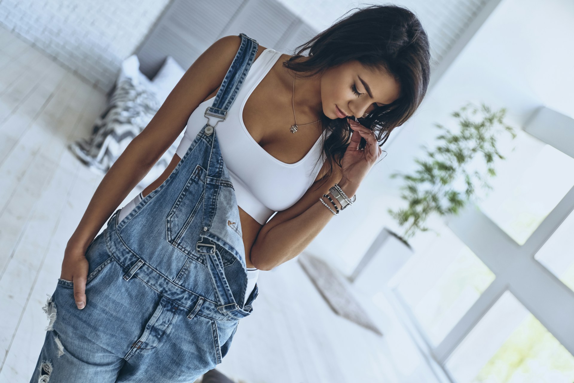 a lady wearing overalls and luxury bracelets a lady wearing overalls and luxury bracelets