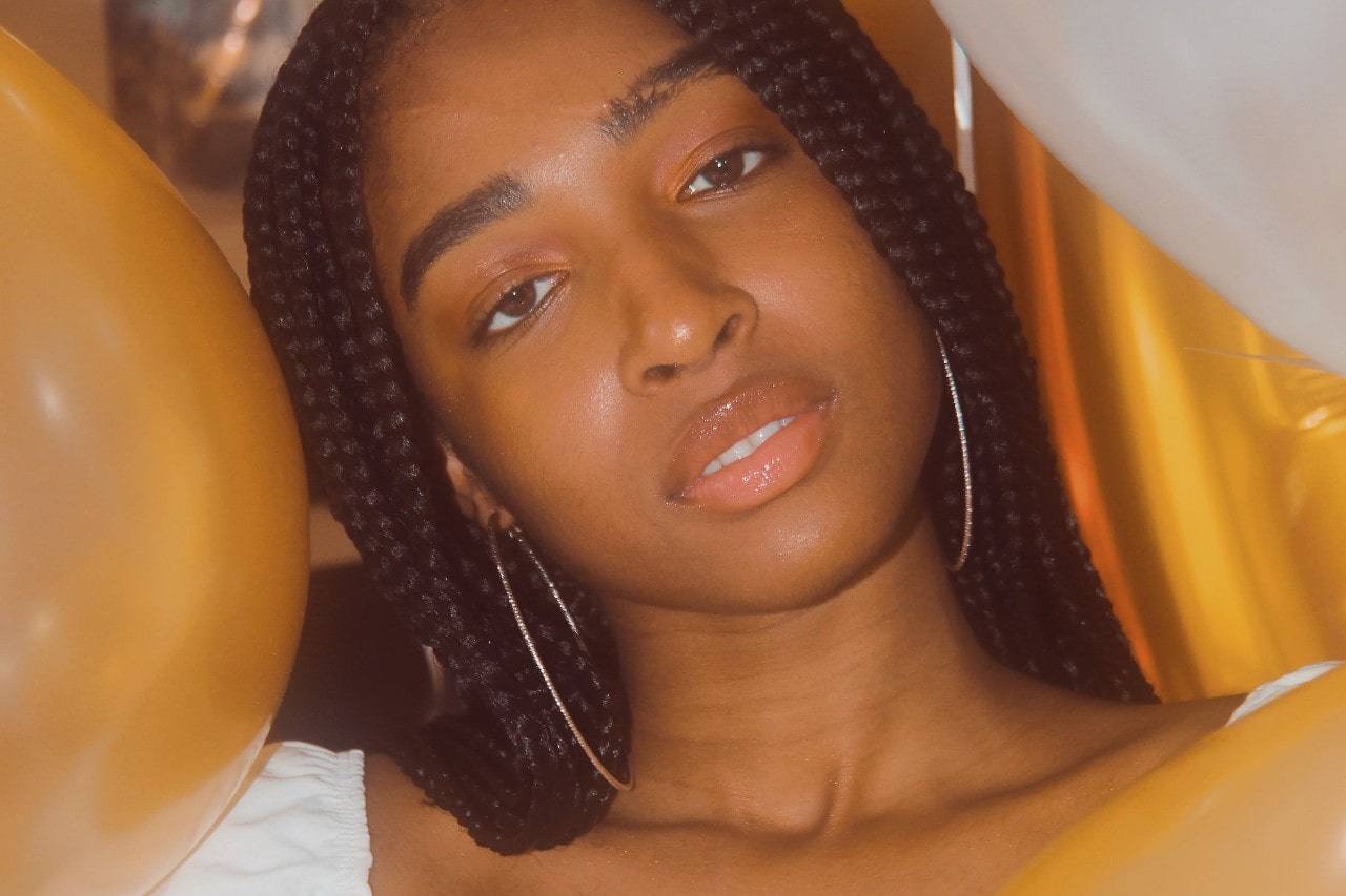 A woman at a party wearing diamond hoop earrings.