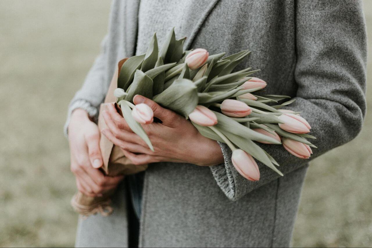 A person holding a bouquet of tulips A person holding a bouquet of tulips