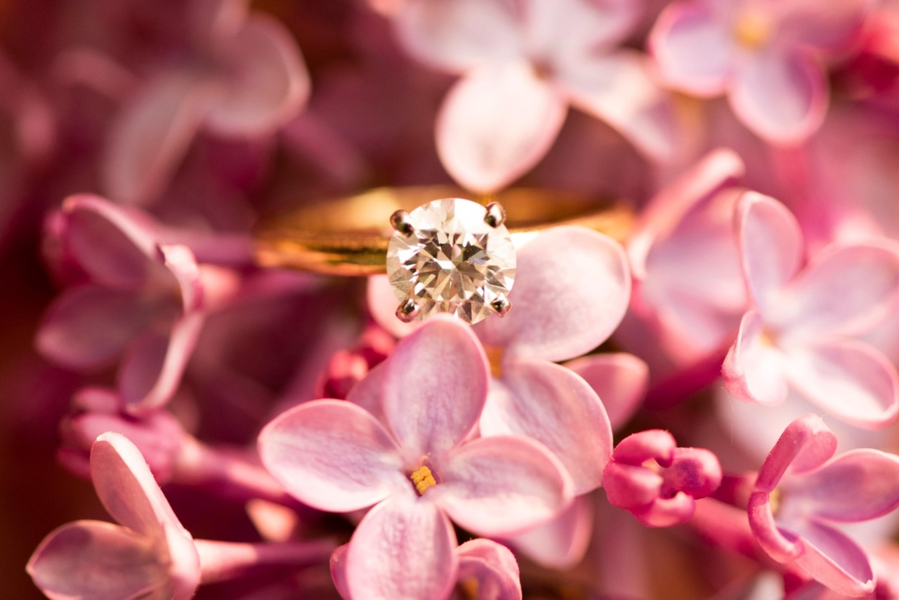 A solitaire engagement ring on a bouquet of flowers A solitaire engagement ring on a bouquet of flowers