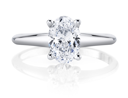 A sleek white gold diamond solitaire ring with an oval cut center stone, available at Rogers Jewelry Co.